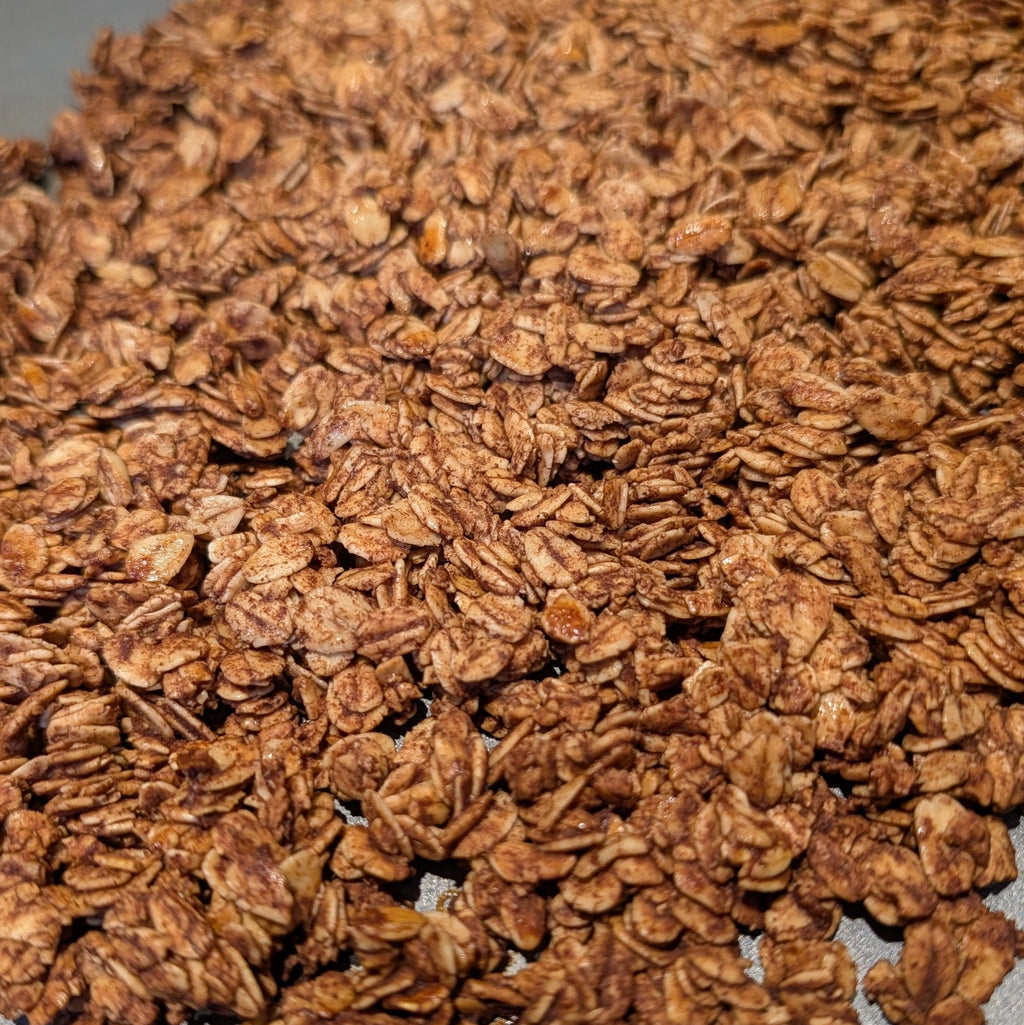 Close-up of a pile of brown granola on a gray surface